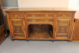A Victorian oak sideboard with carved panel doors
