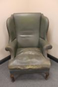 An early twentieth century leather wingback armchair
