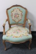 A carved continental salon armchair upholstered in a tapestry fabric