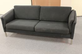 A late twentieth century settee upholstered in black fabric on chrome legs