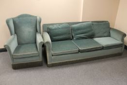 An early 20th century wingback armchair and three seater settee upholstered in blue dralon