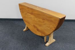 An Ercol pine drop leaf table