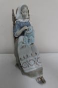 A Lladro figure of a seated lady doing embroidery, No.