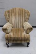 A wingback armchair in striped upholstery