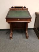 A Victorian mahogany Davenport, width 61 cm, with glass inkwells.