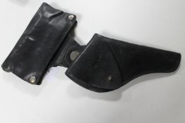 A good quality leather pistol holster with ammunition cover