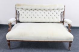 A mahogany two seater salon settee in buttoned upholstery