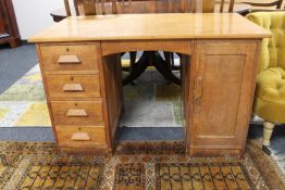 A mid 20th century oak twin pedestal desk