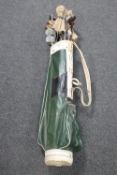 A 1970's golf bag containing drivers and irons CONDITION REPORT: There are no