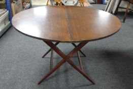 A folding mahogany circular table