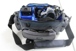A camera bag containing Pentax MX camera with various lenses etc