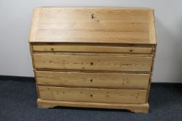 An antique continental pine writing bureau