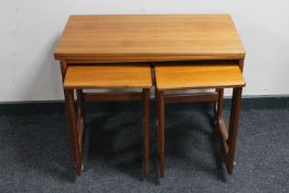 A teak foldover top table fitted two beneath