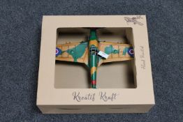 A boxed metal model of a fighter plane