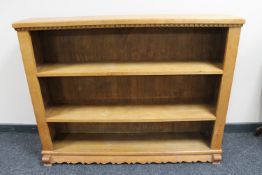 A set of blond oak open bookshelves