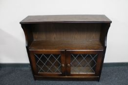 An oak leaded glass low bookcase