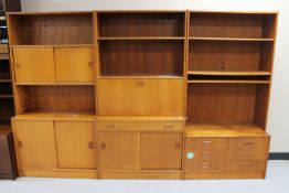 A Danish teak three section sliding door bookcase