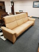 Stressless tan leather reclining three seater and two seater settees.