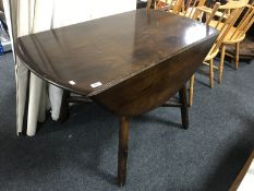 An Ercol elm drop leaf table