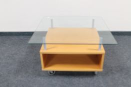 A contemporary glass top lamp table