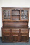 An oak leaded glass door dresser fitted cupboards beneath