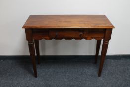 A contemporary stained pine side table fitted a drawer
