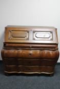 A 19th century oak bombe bureau CONDITION REPORT: The upper bureau section lifts