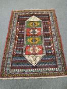 A Caucasian rug on polychrome ground,