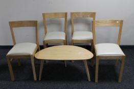 A contemporary pebble coffee table together with a set of four contemporary leather seated dining