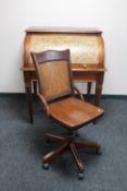 A contemporary stained pine roll top desk and a swivel chair