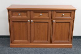 A contemporary teak effect triple door sideboard