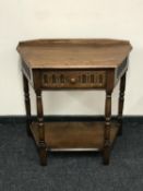 A shaped oak hall table fitted a drawer