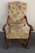 An early 20th century carved continental oak armchair in floral brocade