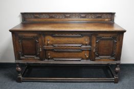 A Victorian carved oak sideboard