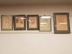 Five framed pencil drawings depicting 