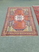A Caucasian rug on red ground,