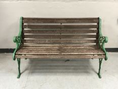 A cast iron and wooden slatted garden bench