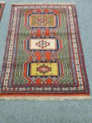 A Caucasian rug on red ground,