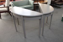 A pair of painted D-shaped hall tables