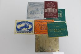 A group of vintage motoring show badges