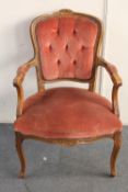 A carved beech framed salon armchair in pink dralon
