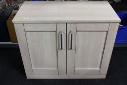 A pine effect double door cabinet
