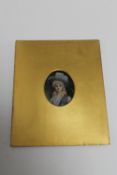 A nineteenth century portrait miniature depicting a lady wearing a blue dress and hat.