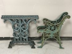 A pair of cast iron bench ends and a pair of cast iron table bases