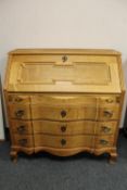 A continental oak serpentine front bureau,