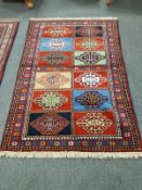A Caucasian rug on red ground,