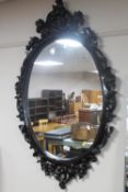 A wooden framed Rococo style mirror