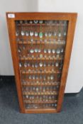A display case containing a large quantity of crested teaspoons