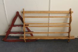 A blonde oak wall shelf and painted triangular wall shelf