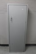 A metal gun cabinet with keys